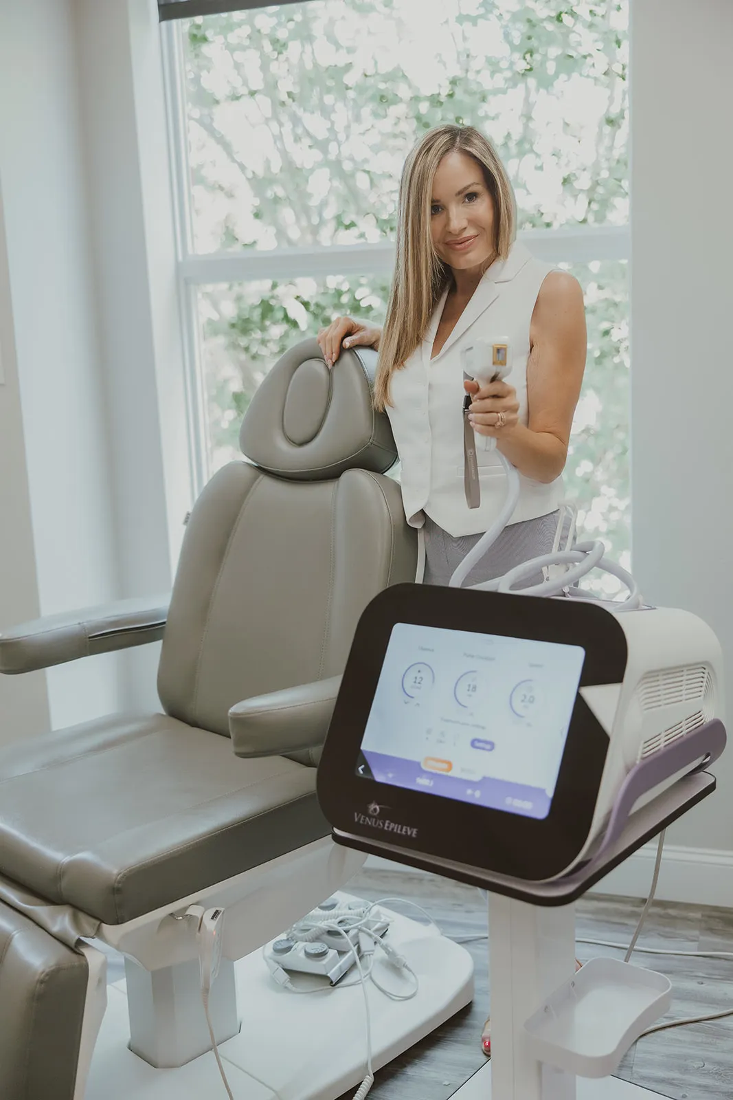 Amy Palacios, FNP, at her medspa window with the Venus Epileve handpiece in hand.
