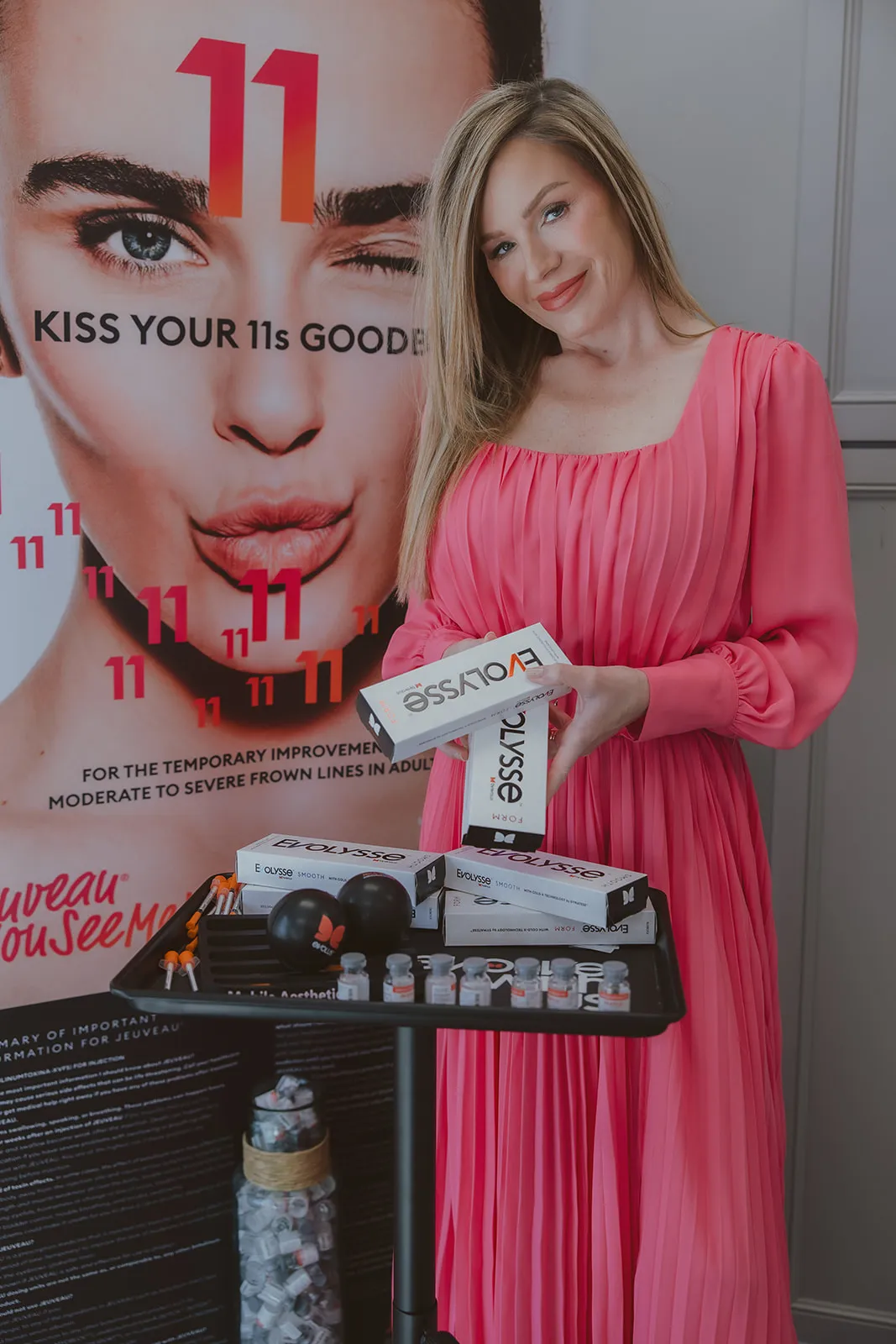 Amy Palacios, FNP, holding Evolysse cartons at her medspa cart.
