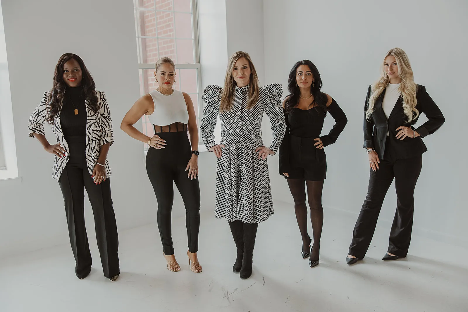Amy with the Mobile Aesthetics team, standing together in a white studio.